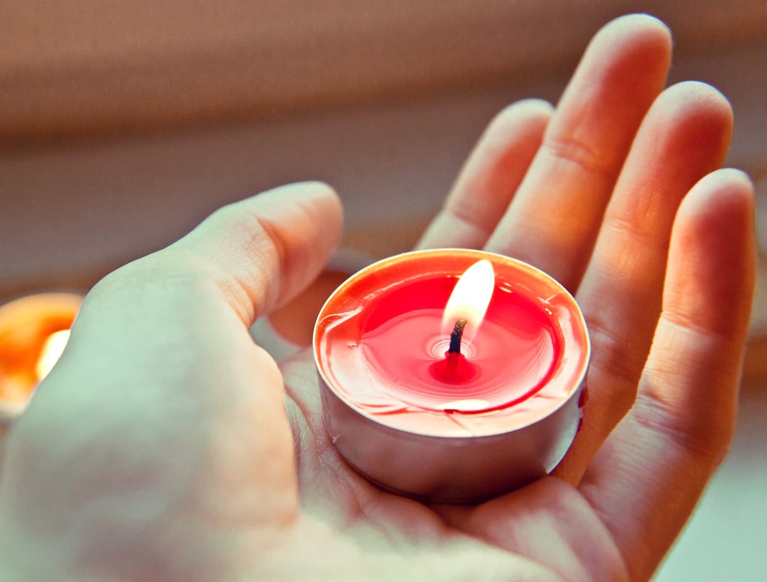 Person holding a red and white candle